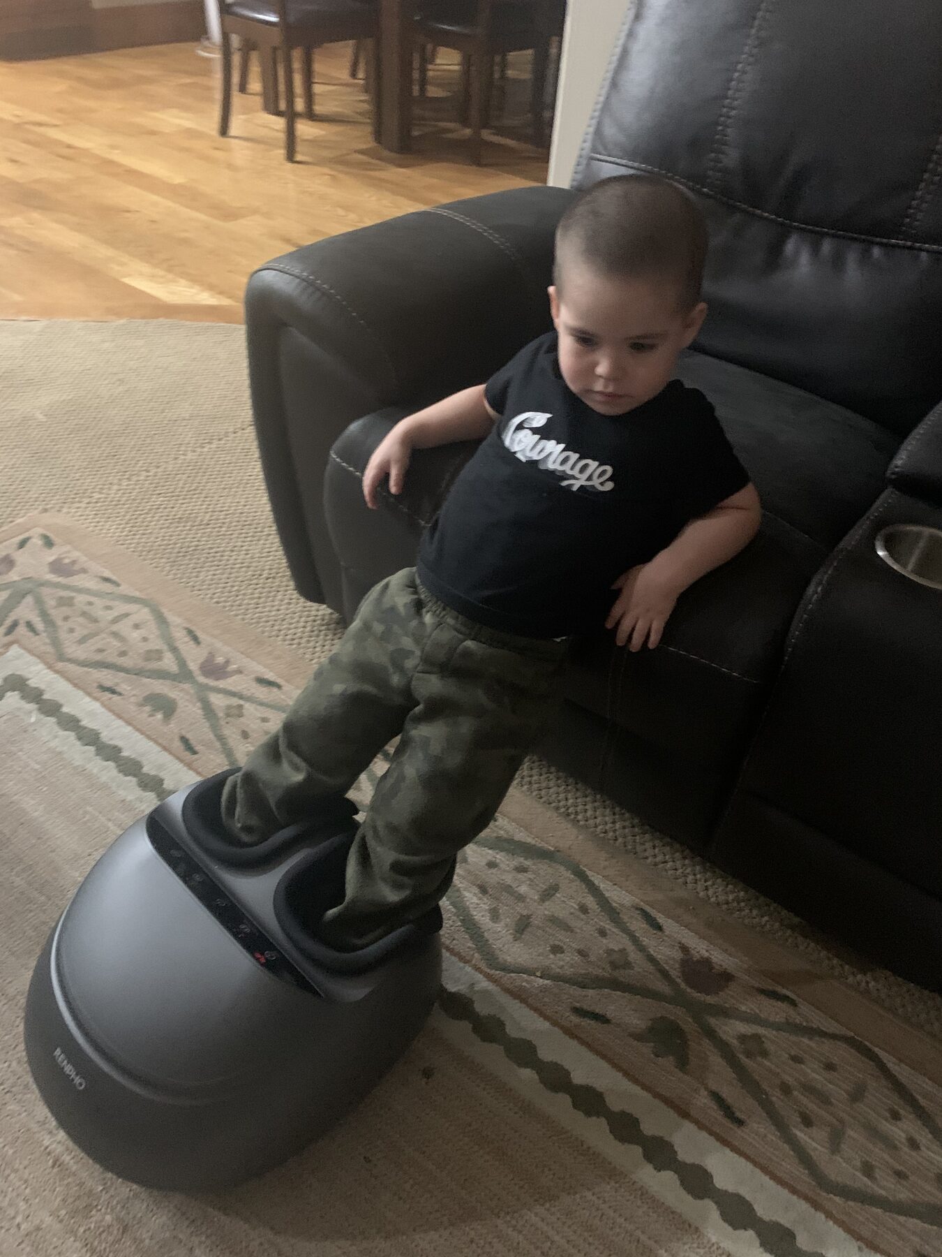 Young Oliver relaxing in a massage chair.