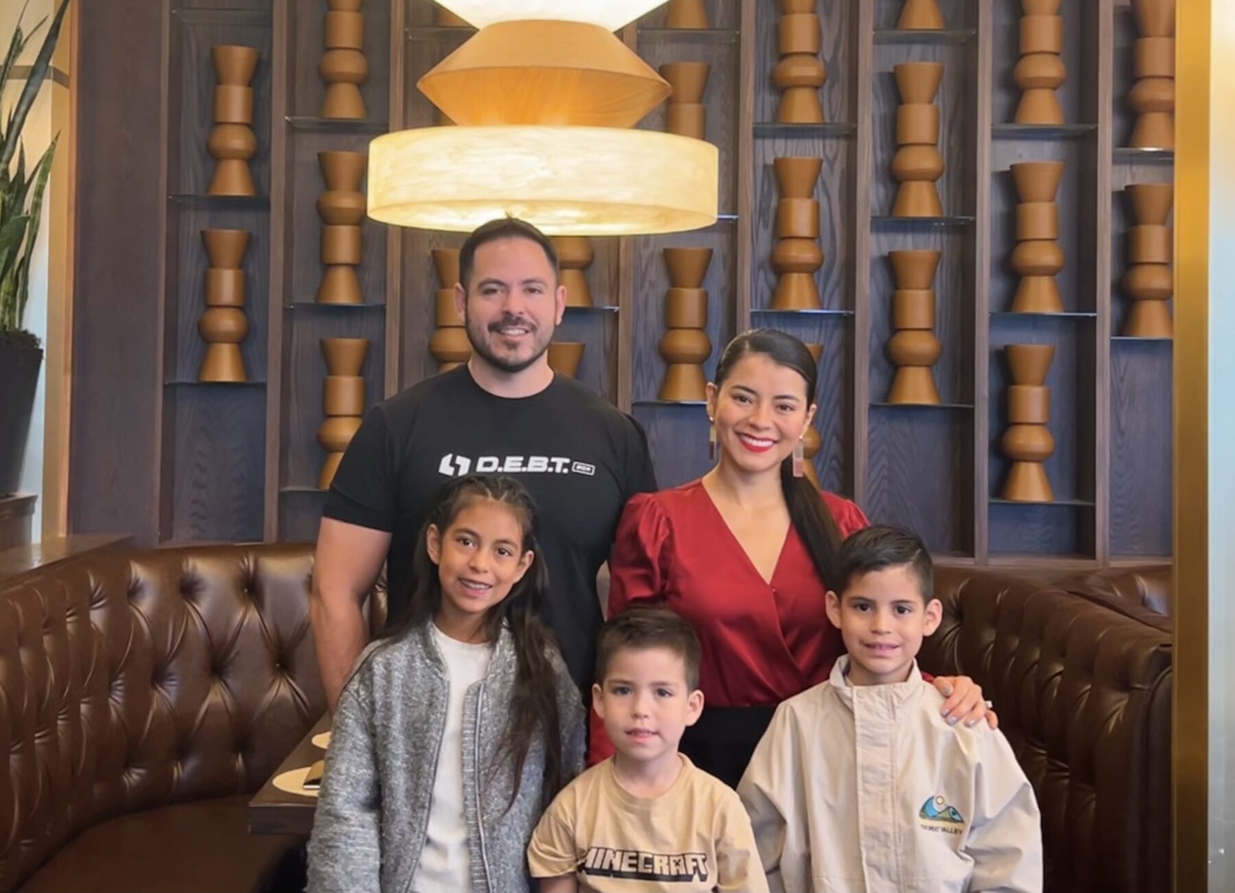 Oliver smiling with family during a trip.