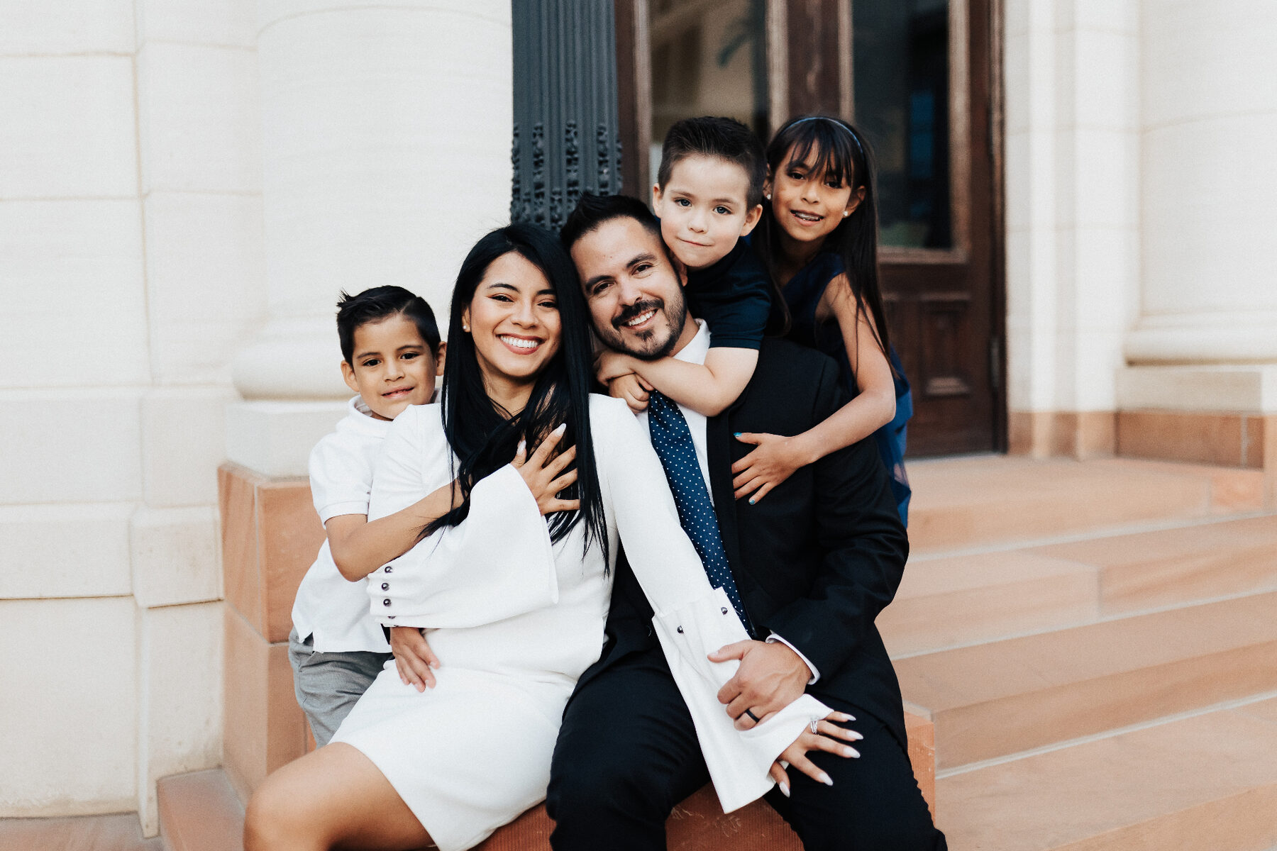 Oliver cuddled close with his family outside the temple.