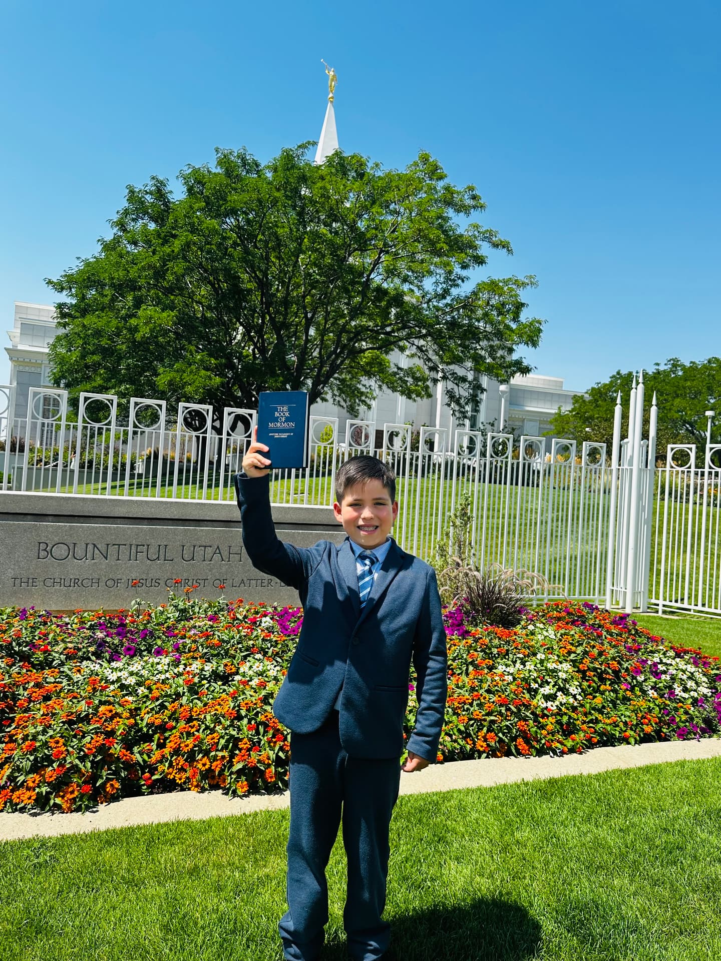 Oliver Anthony Martinez holding the Book of Mormon outside the Bountiful Utah Temple.