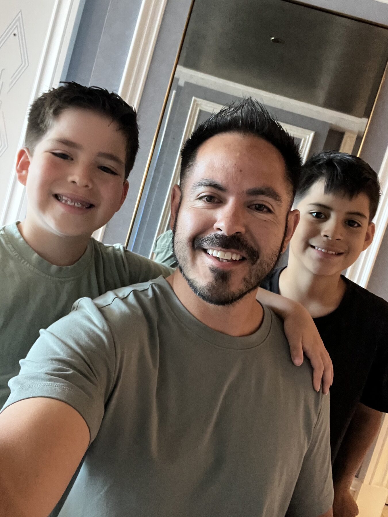 Oliver and his brother taking a selfie with their dad.