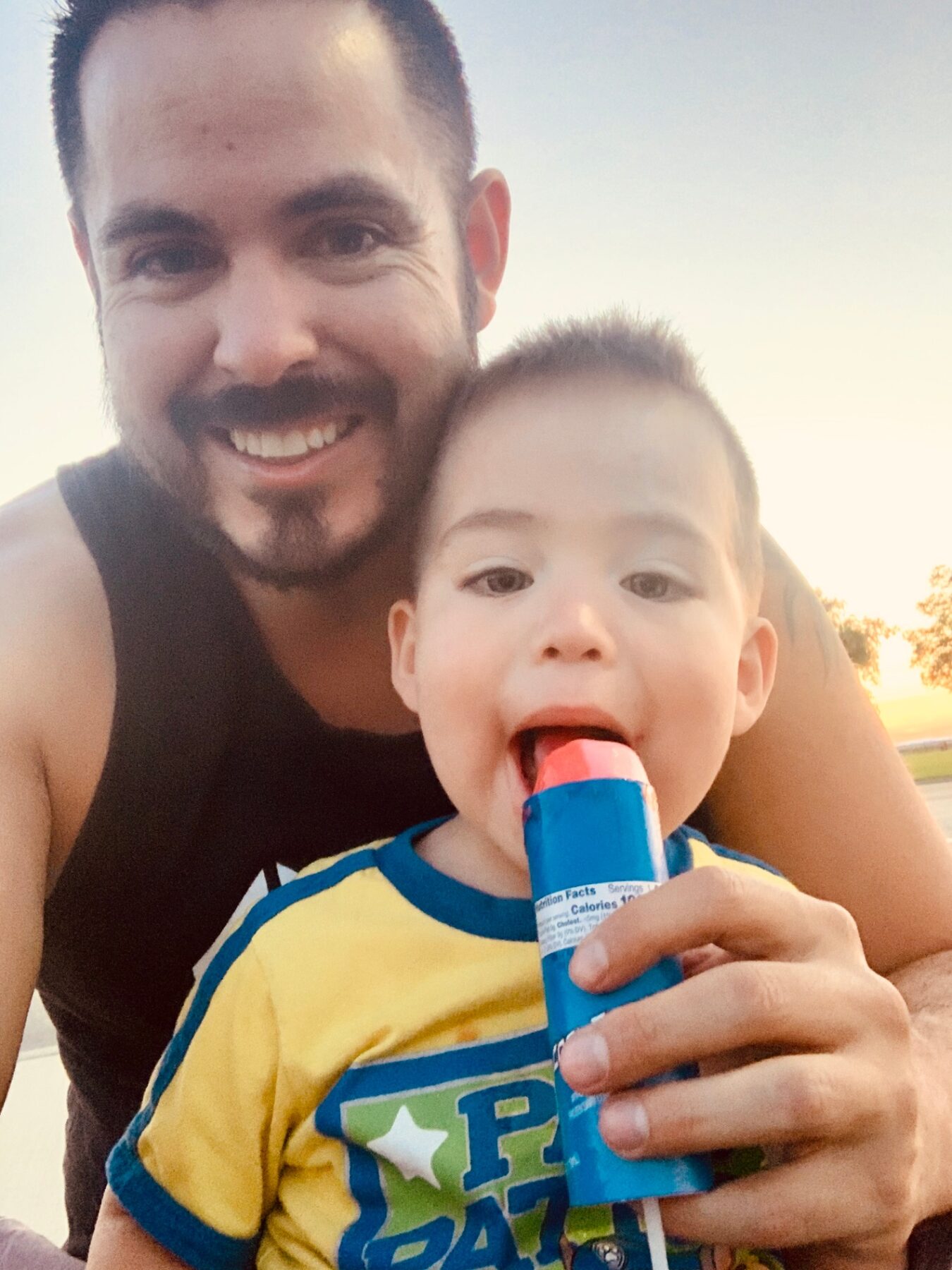 Oliver as a baby sharing a frozen treat with his dad.